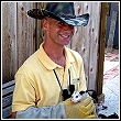 wildlife whisperer holding a young possum